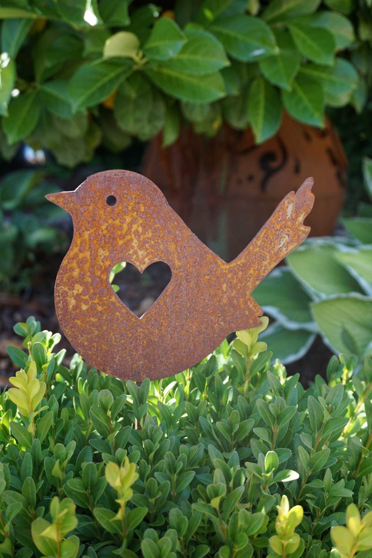 Little bird with heart on stick