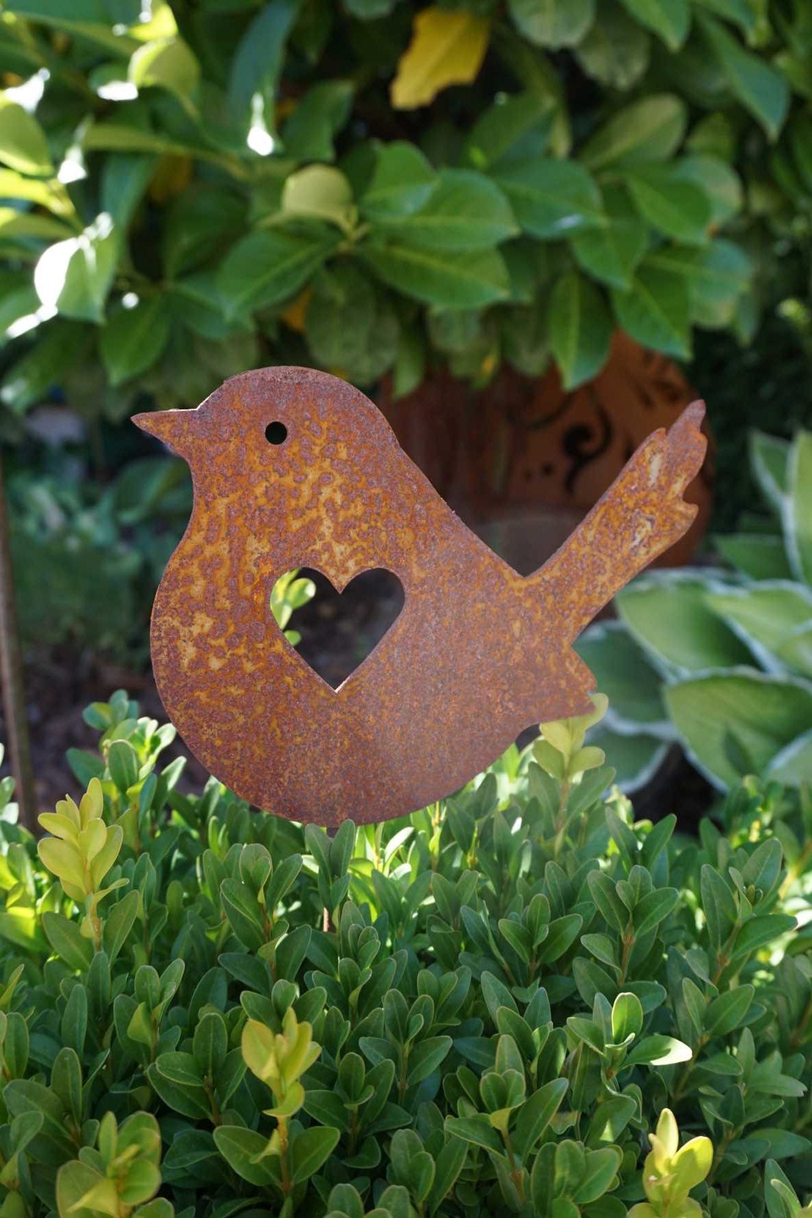 Little bird with heart on stick